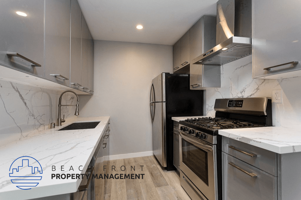 an updated kitchen with stainless steel appliances and marble counter tops