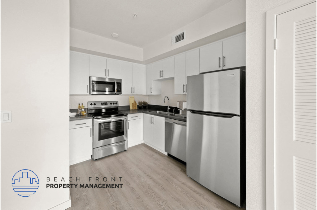 a kitchen with white cabinets and stainless steel appliances