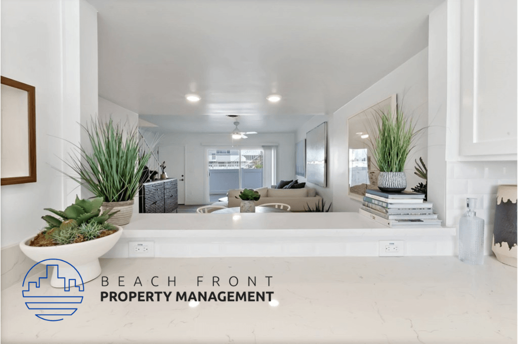 a view of a living room from the kitchen of a beach front property management advertisement