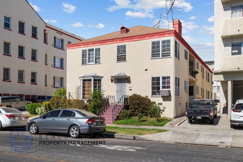 a house with a red roof on a city street