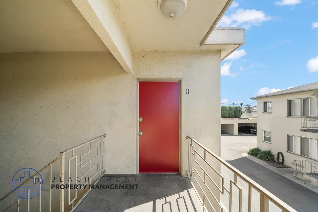 A red door is the focal point of this image.