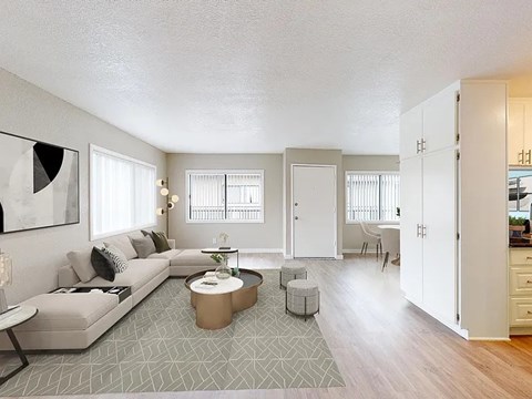 A living room with a grey couch and a coffee table.