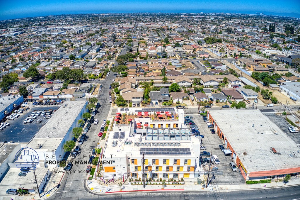 an aerial view of a city with a parking lot and buildings
