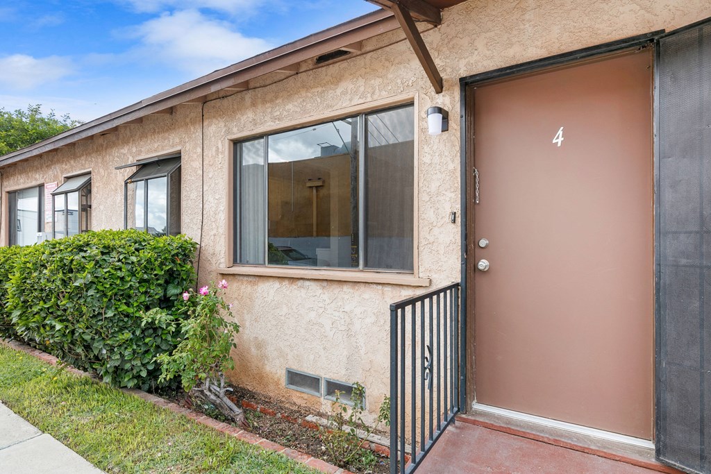 the entrance to a building with a brown door