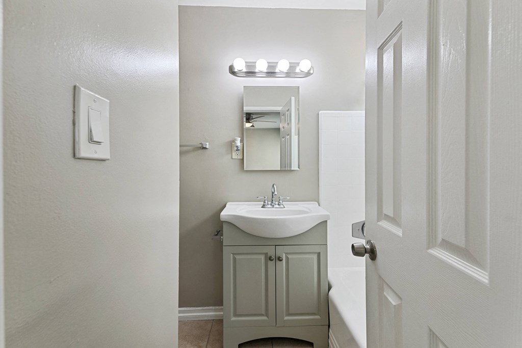 a small bathroom with a sink and a mirror