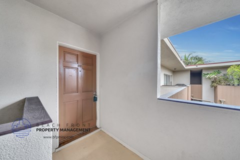 a door is open to the balcony of a condo