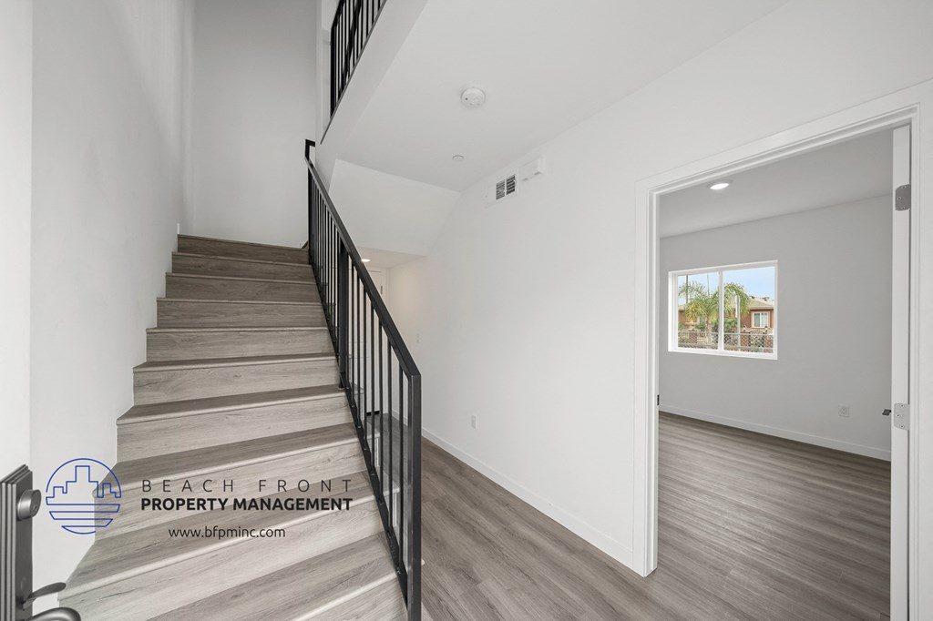 a view of a staircase in a home with wood flooring and white walls