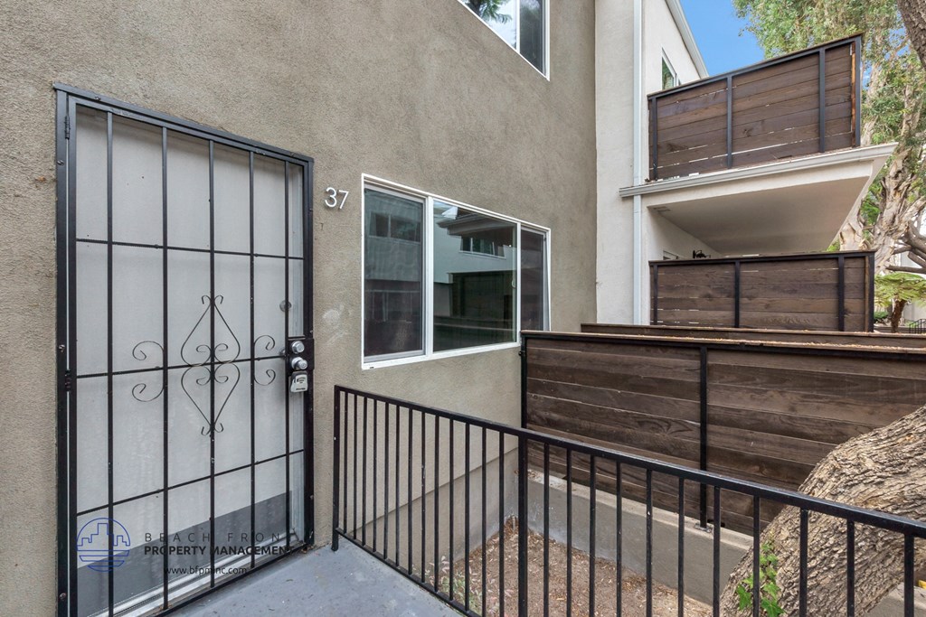 the entrance to a building with a gate and a balcony