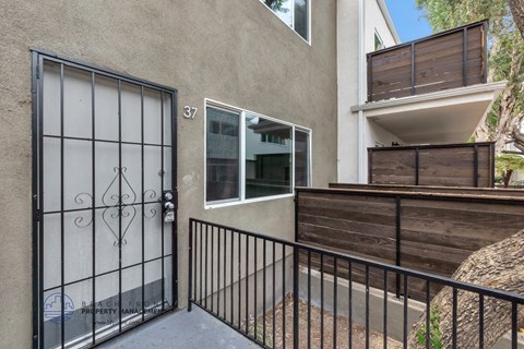 the entrance to a building with a gate and a balcony