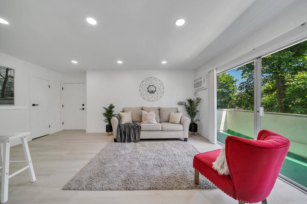 a living room with a couch and a chair and a rug