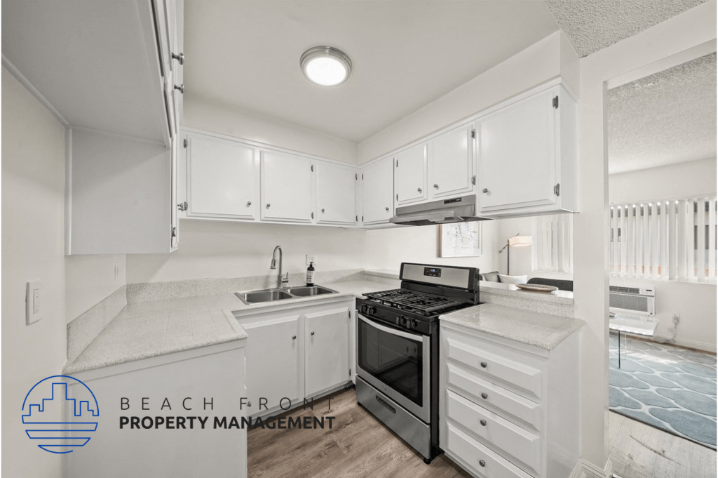 a kitchen with white cabinets and a stove and a sink