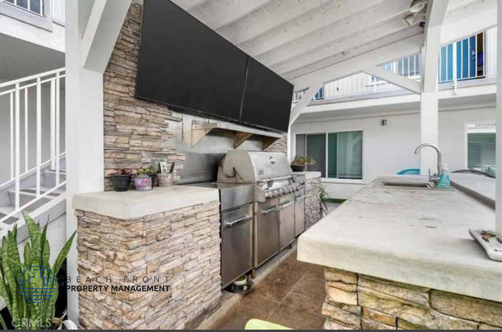 a kitchen with a large stove and a tv on the wall