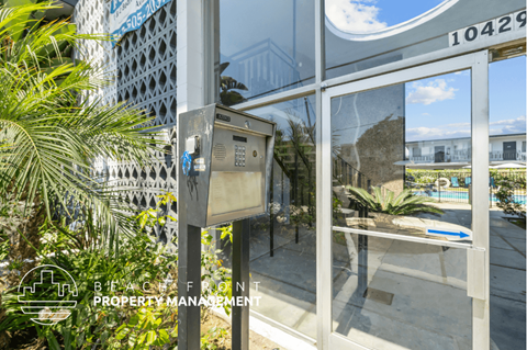 a parking meter in front of a glass door