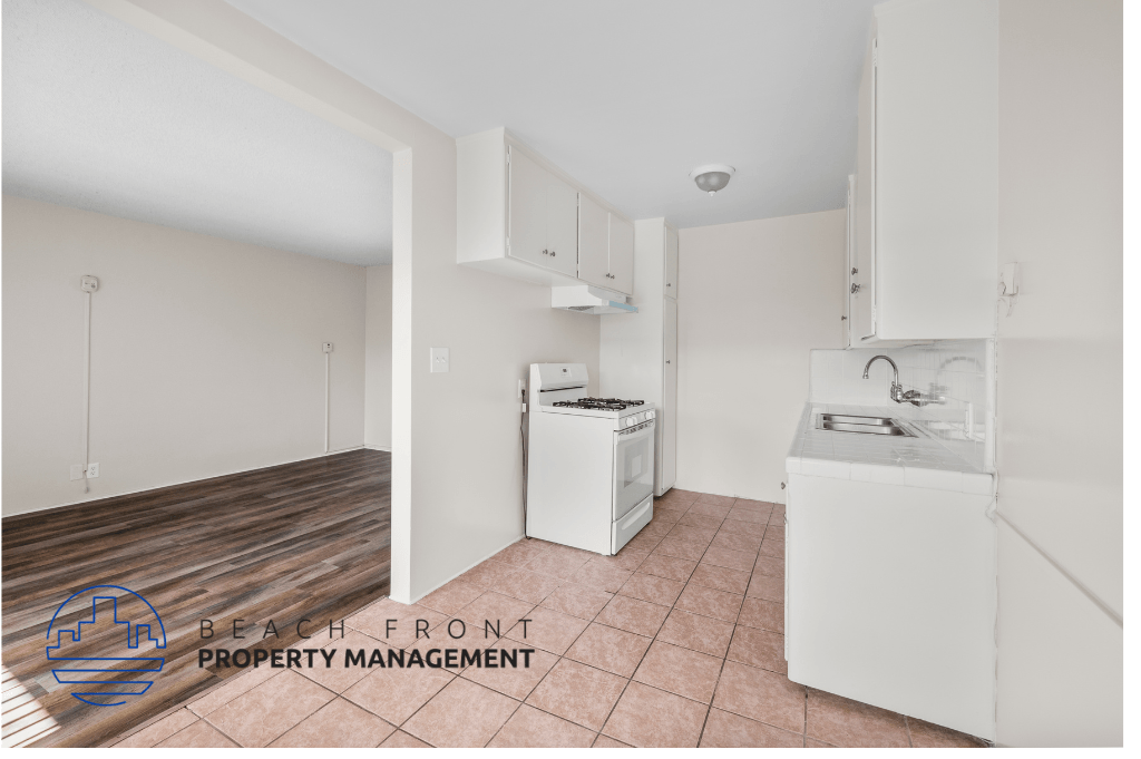 a kitchen with white cabinets and a stove and a sink