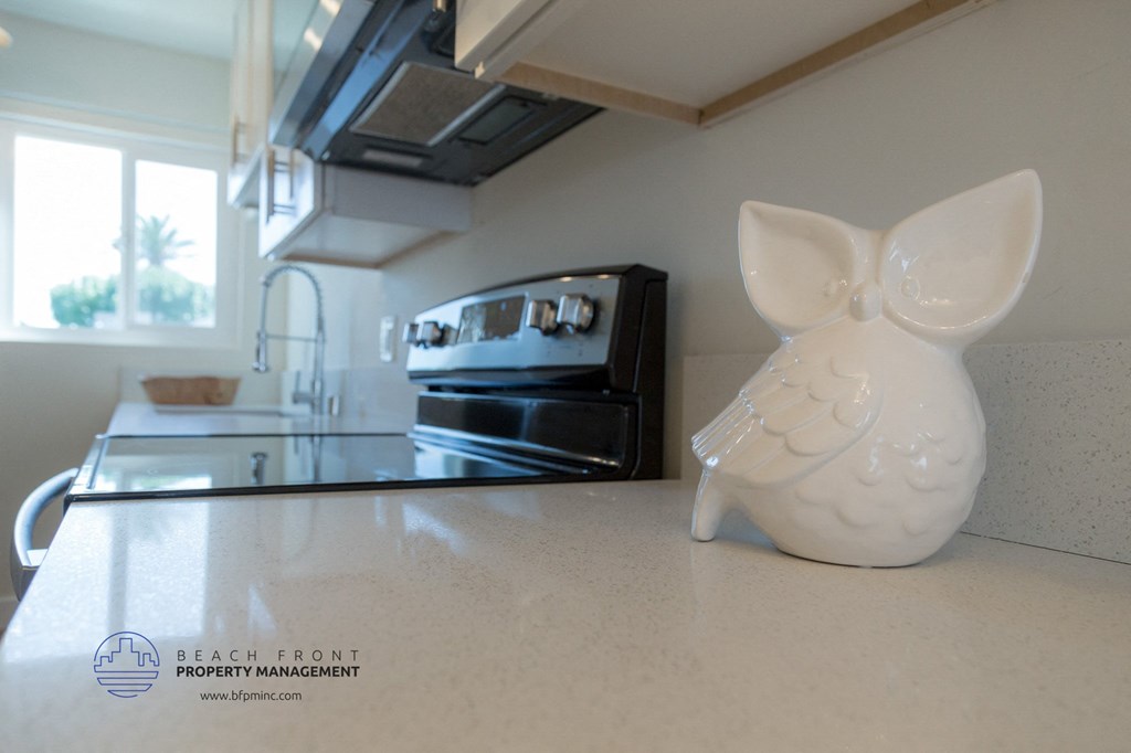 A white rabbit figurine is sitting on a kitchen counter.