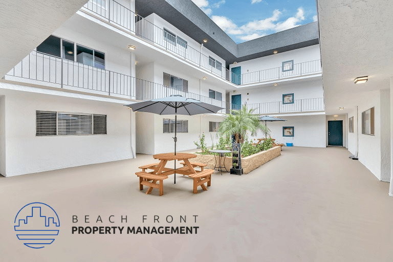 a patio with a picnic table and chairs in a building