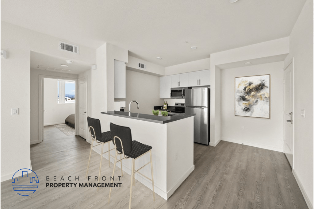 a kitchen with white cabinets and a island with black counter tops