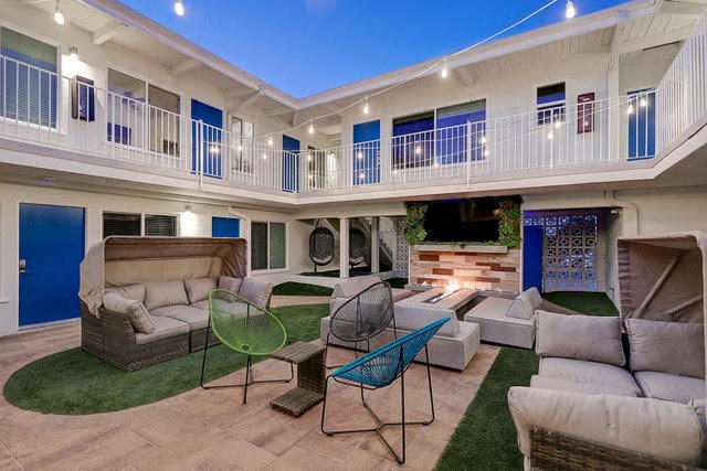 a living room with couches and chairs and a fireplace