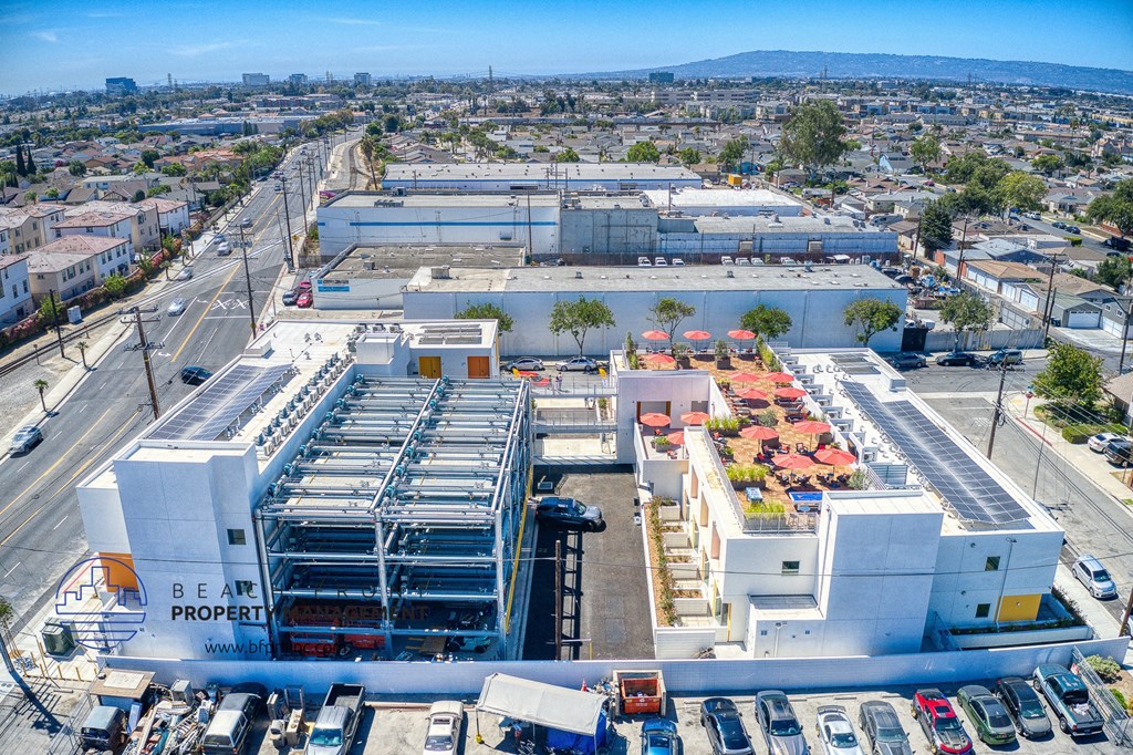 an aerial view of a large building with cars parked outside of it