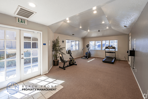 A gym with a treadmill, exercise bike, and weights is labeled as an exit.