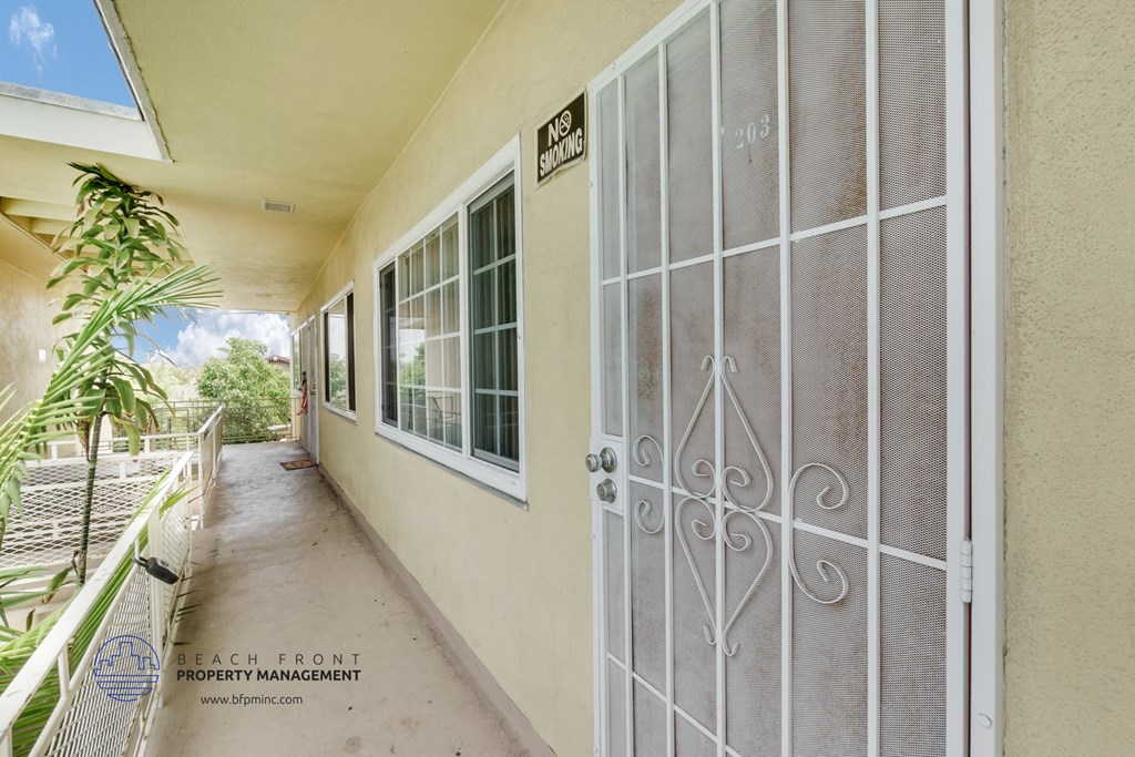 a large white door with a metal gate on the side of a building