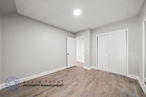 the living room of a new home with white walls and wood flooring