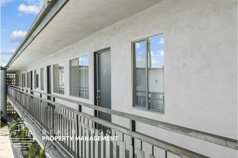 a view of a building with windows and a balcony