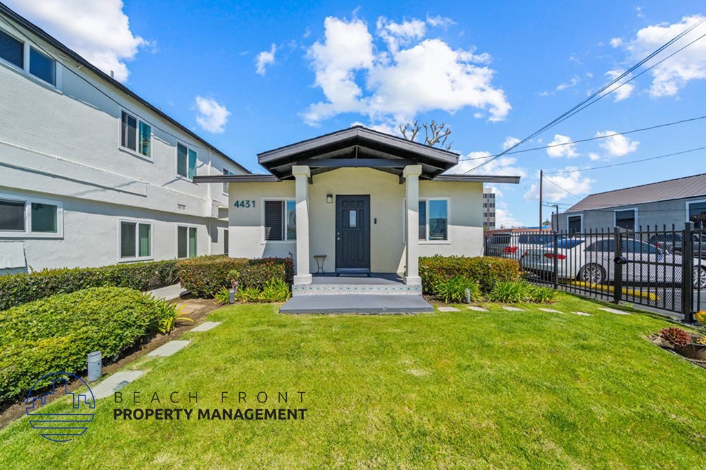 a view of a building with a lawn in front of it