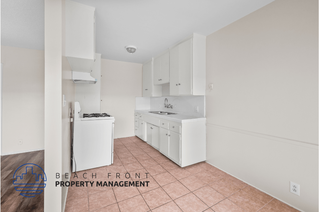 a white kitchen with white appliances and white cabinets