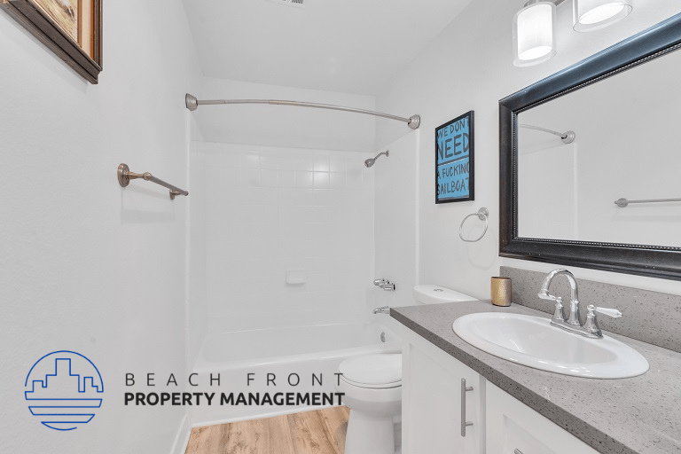 a bathroom with a sink and a shower and a mirror