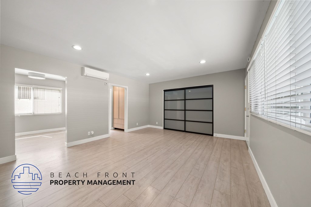 A spacious room with a logo for Beach Front Property Management.