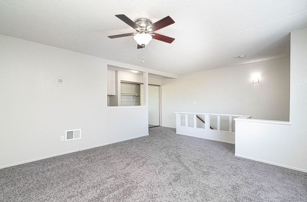 Loft style bedroom with AC and ceiling fan