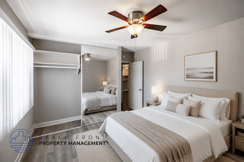 A bedroom with a large bed and a ceiling fan.