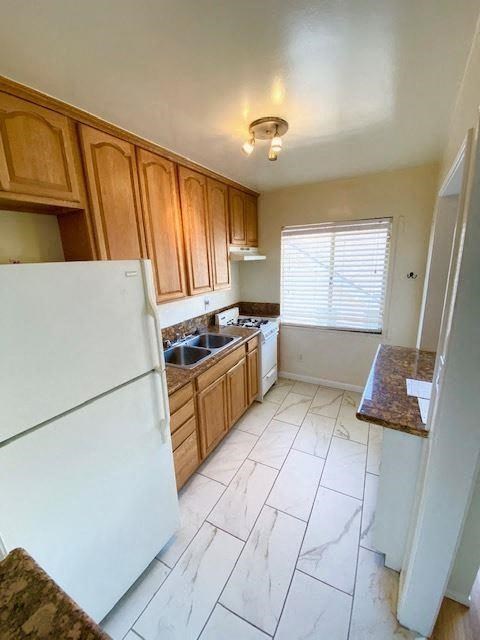 a small kitchen with a refrigerator and a sink