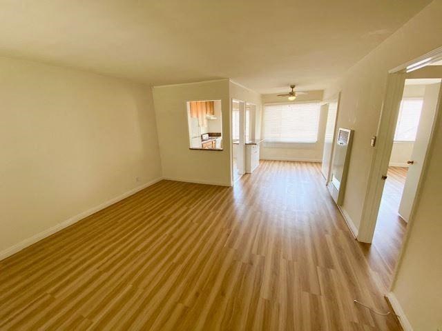 a empty living room with a wooden floor