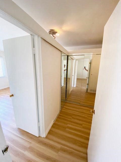 a hallway with white doors and a wood floor