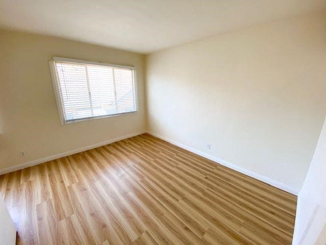 an empty room with a wooden floor and a window