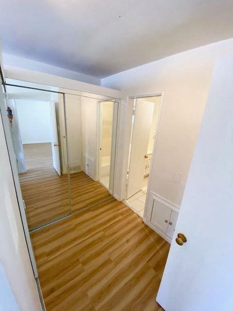 a empty room with a mirror and a wooden floor