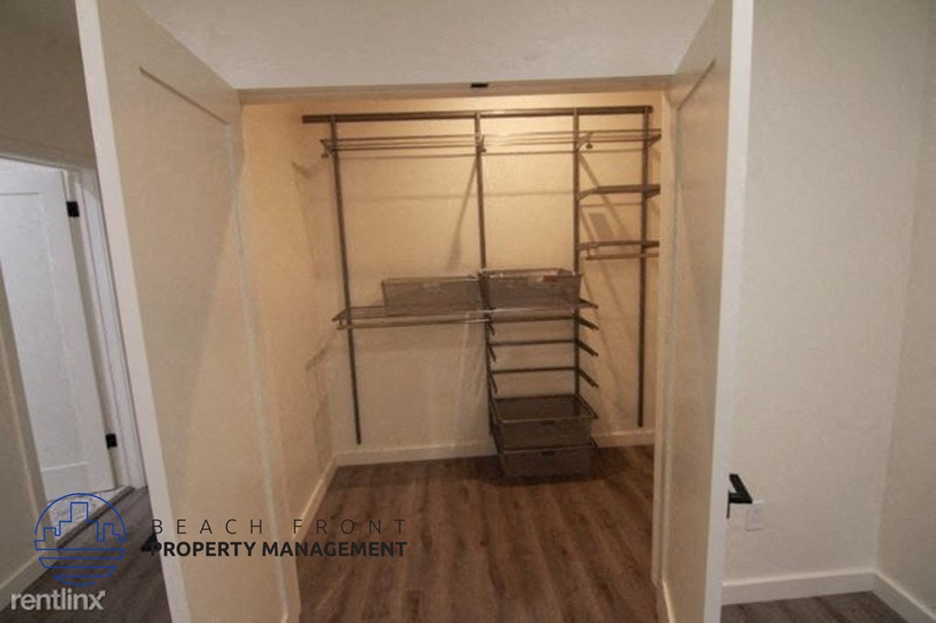 a large closet in a small room with a wooden floor