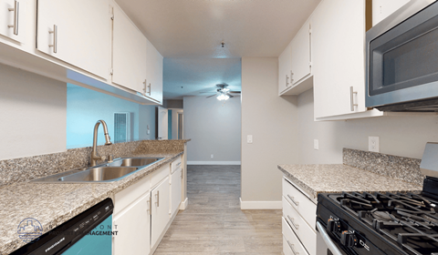 A kitchen with granite countertops and stainless steel appliances.