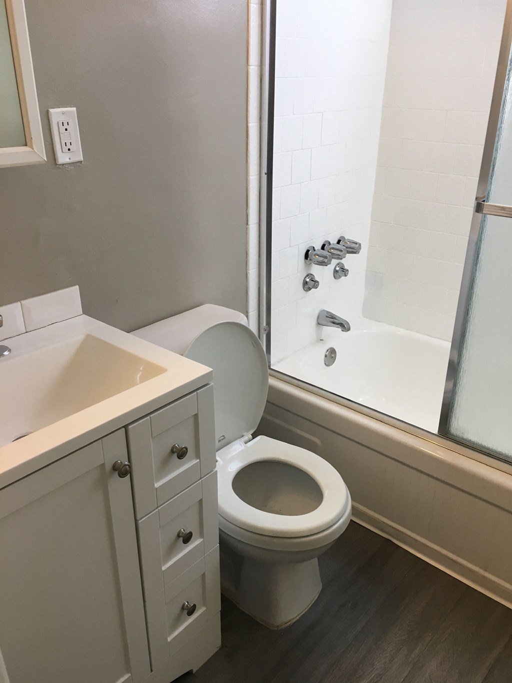 an empty bathroom with a toilet and a shower