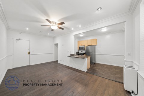 a large room with white walls and a ceiling fan