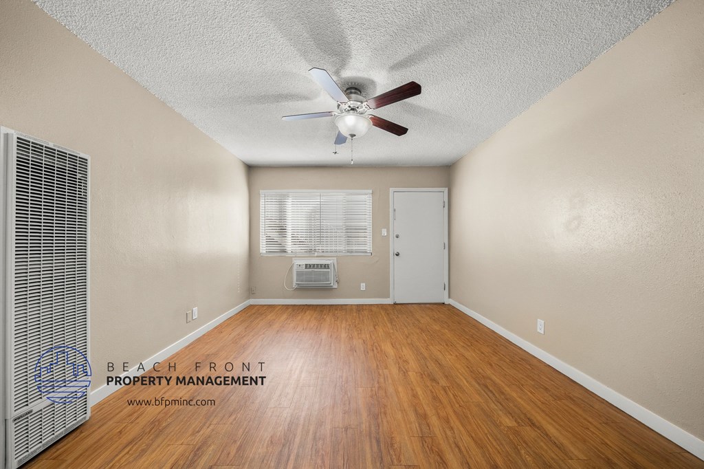 a living room with hardwood floors and a ceiling fan