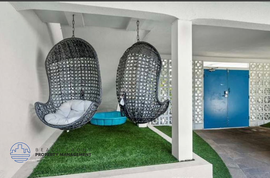 two hanging egg chairs in a room with grass