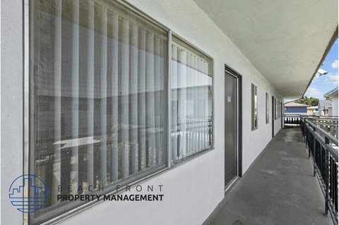 a view of the front of a building with windows and a balcony
