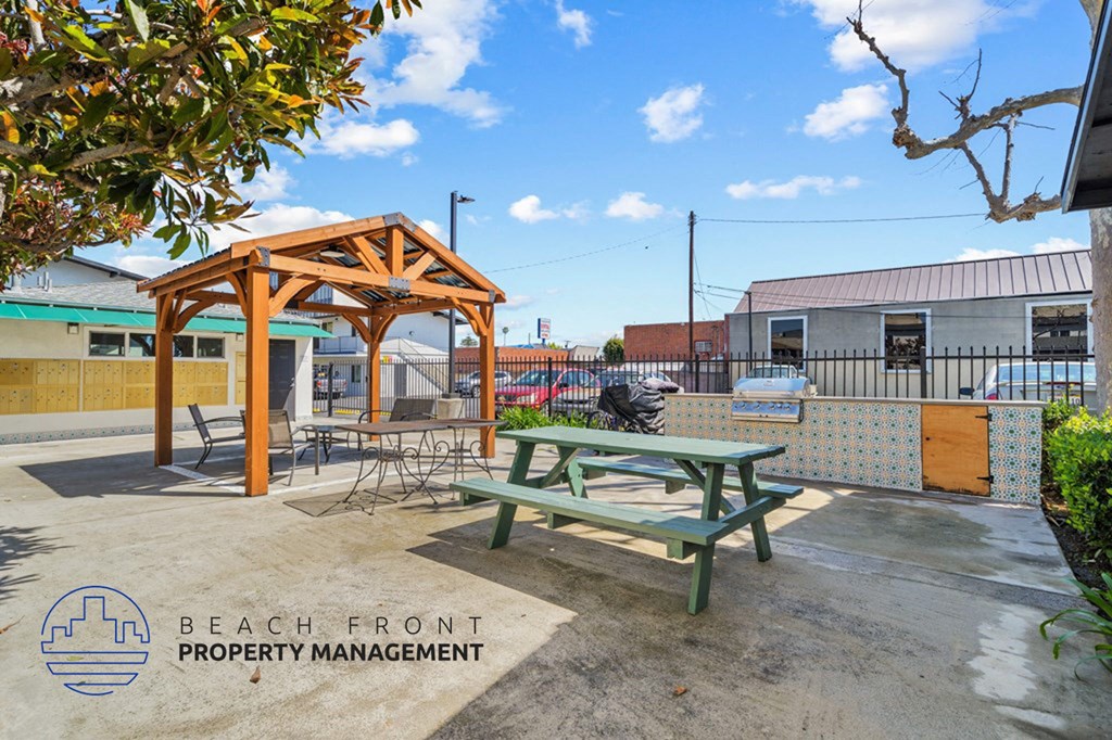 a picnic table in a patio area with a picnic bench