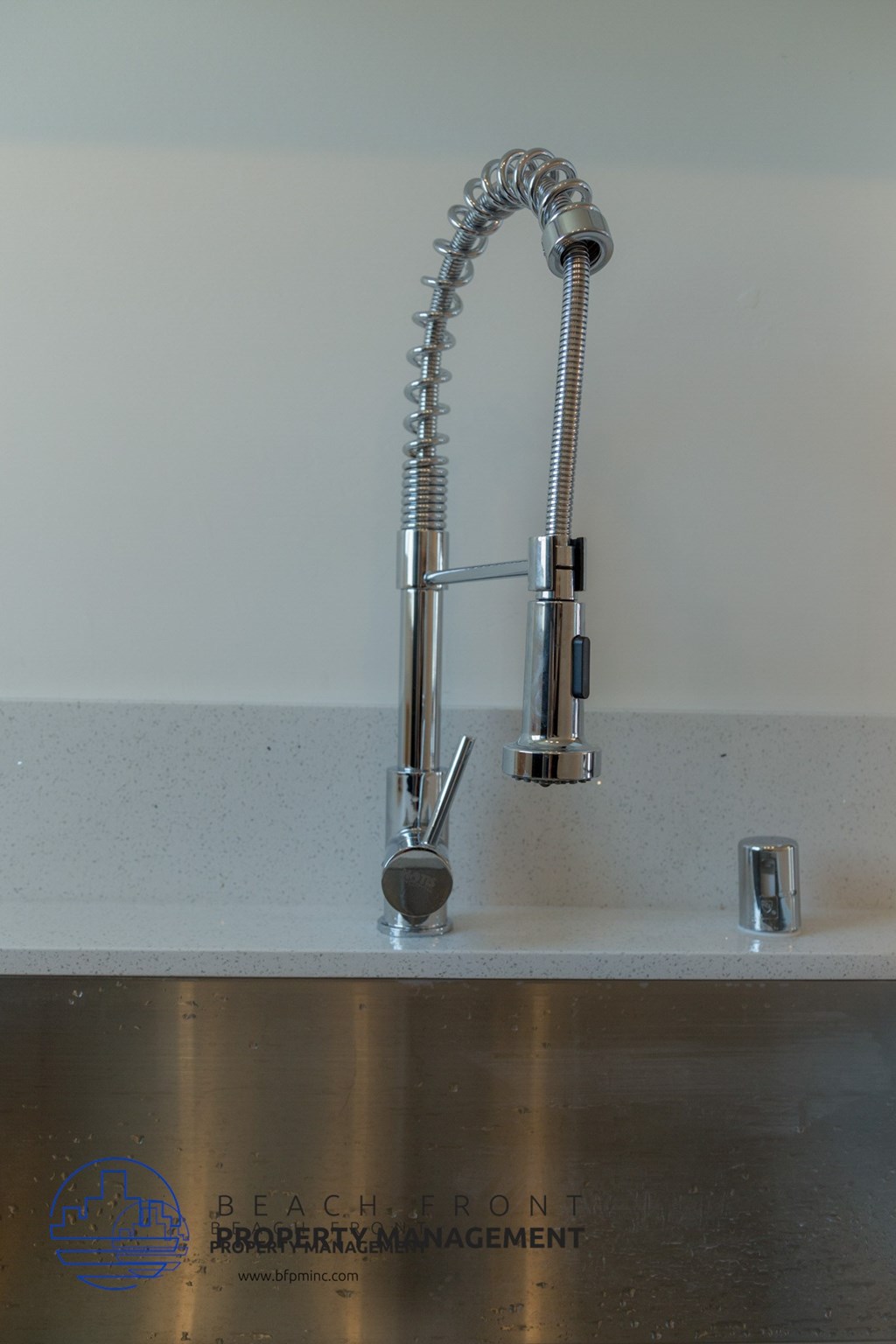 A chrome bathroom sink faucet with a pull out sprayer.
