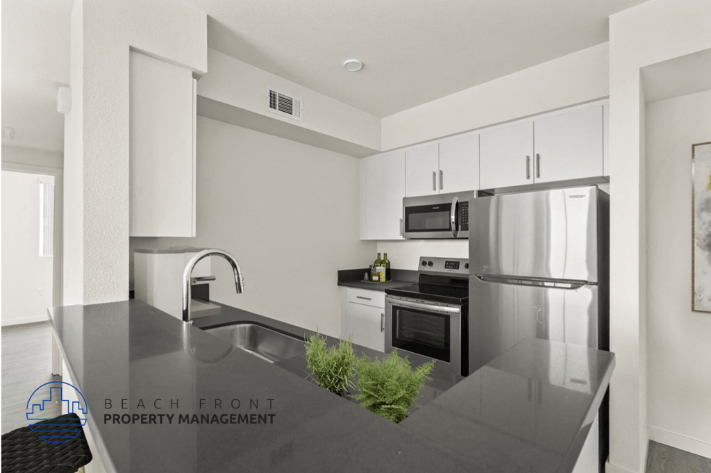 a modern kitchen with stainless steel appliances and black counter tops