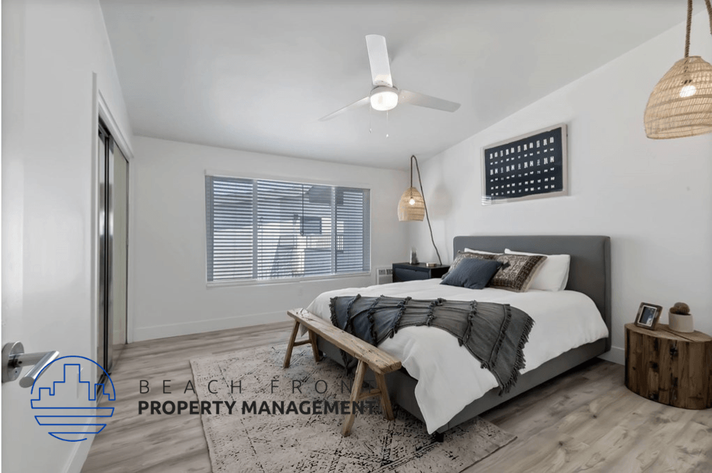 a bedroom with a bed and a ceiling fan