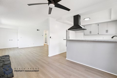 A spacious room with a fan and a countertop.
